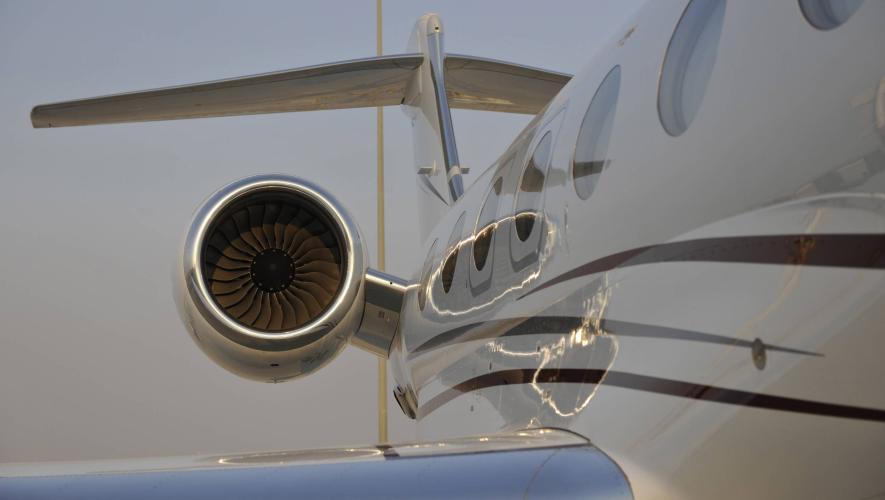 partial view of business jet parked at airport