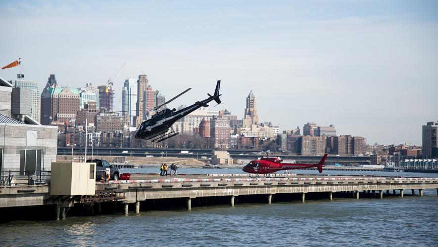 Blade helicopters at heliport in NYC, one coming in for landing