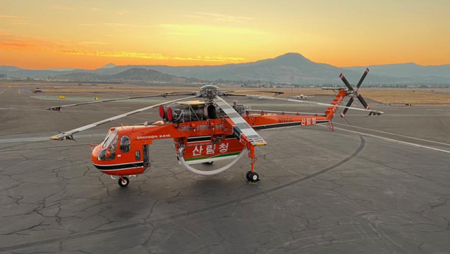 Overhead view of Erickson S-64 Air Crane on airport ramp at sunset