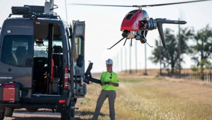 Phoenix Air Unmanned drone operator flies drone near company van