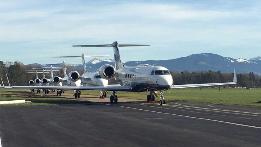 business jets lined up on ramp