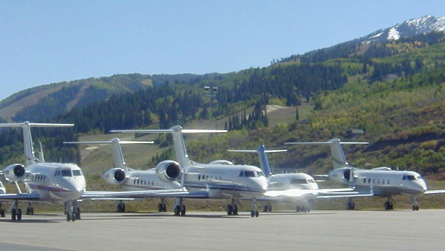 business jets lined up on ramp at Aspen-Pitkin County Airport