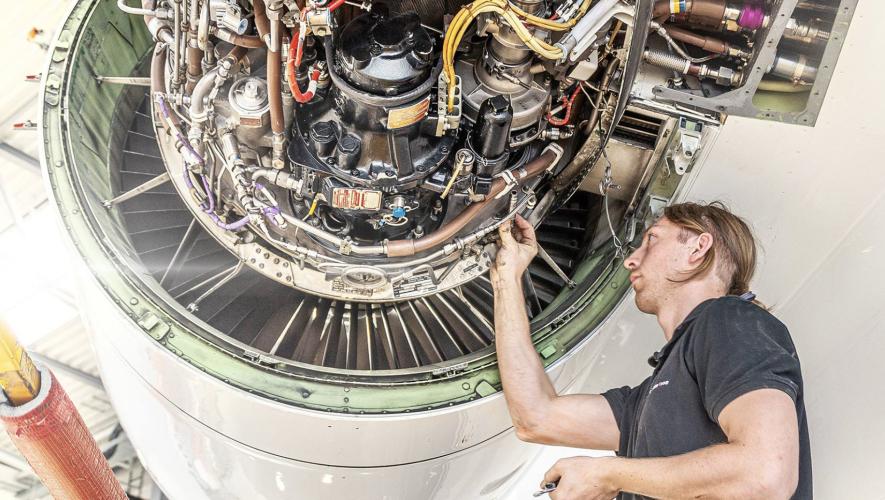 FAI Technik aircraft maintenance technician at work on jet engine