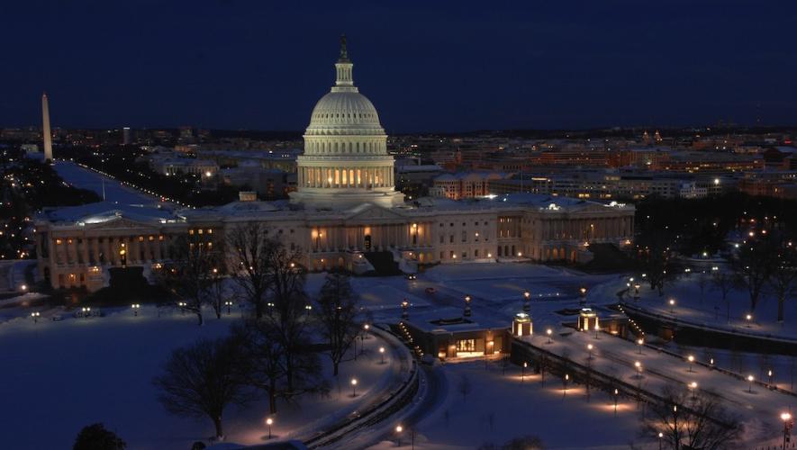 Aerial view of U.S. Capitol building illuminated at night