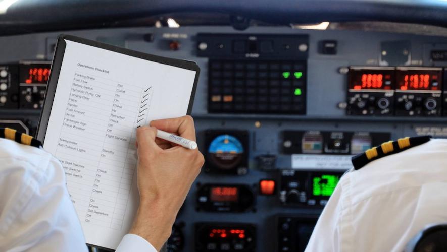 pilots reviewing checklist in flight deck
