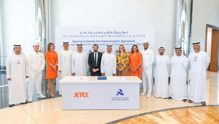 Jetex and Abu Dhabi Airports representatives at table during signing ceremony for concessionary agreement