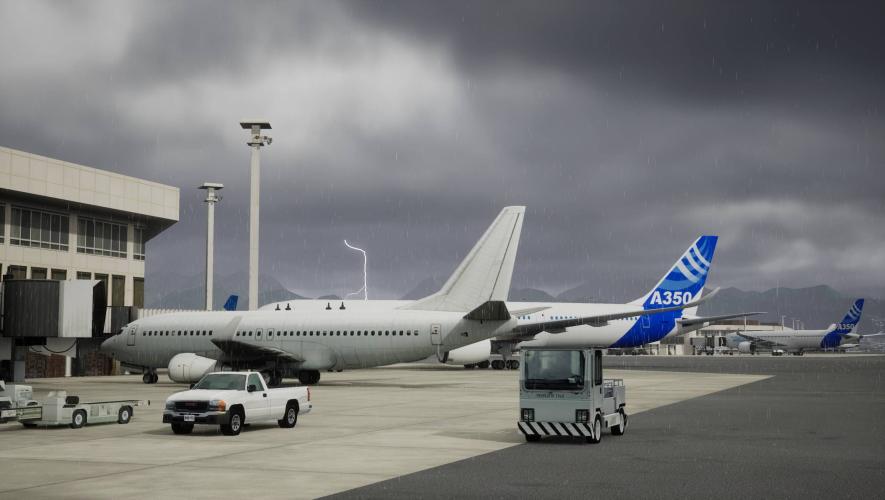 Photorealistic simulated image of airliners and ground vehicles at airport terminal during a rainstorm from FlightSafety simulator visual system using Unreal Engine