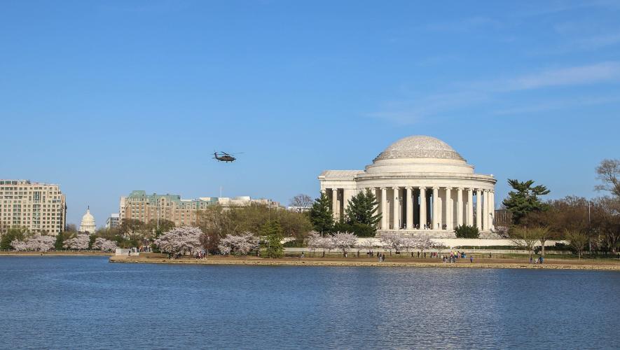 Military helicopter in flight over Jefferson Memorial in Washington D.C.