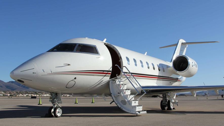 NetJets aircraft on airport ramp with door open
