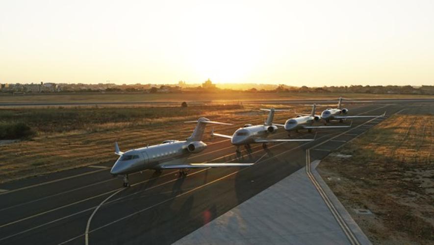Vista fleet lined up on airport taxiway at sunset
