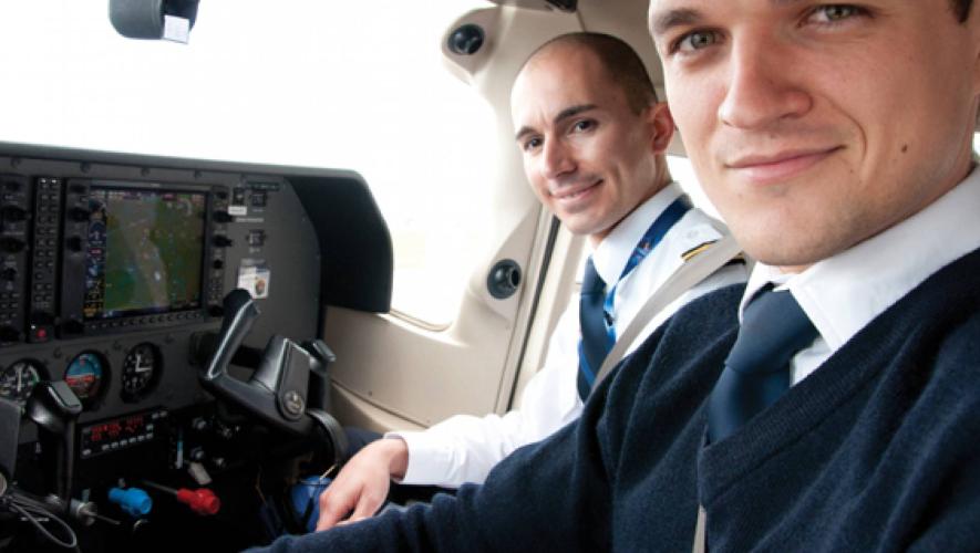 Pilots in cockpit of small aircraft