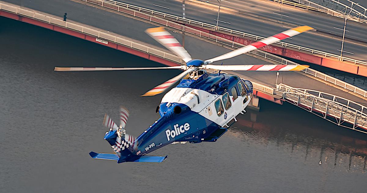 Australian Police AW139 helicopter in flight over bridge