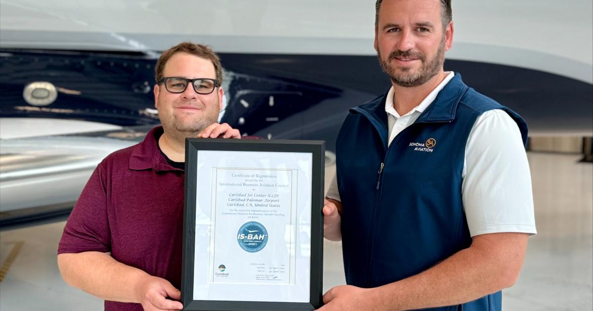 Sonoma Aviation’s safety manager Josh Foster and Clayton Lackey, v-p, present their IS-BAH Stage 3 certification.
