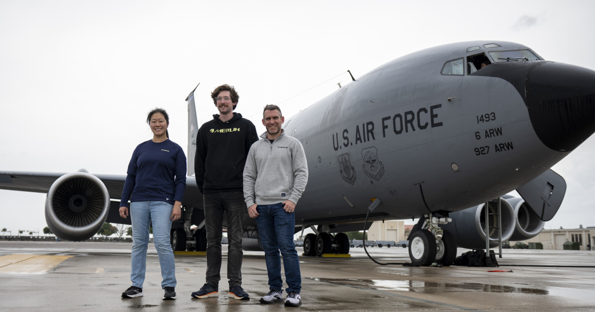 Merlin engineers Josie Cater, Nick Lepore, and Carl Pankok pose for a photo in front of a Boeing KC-135 Stratotanker