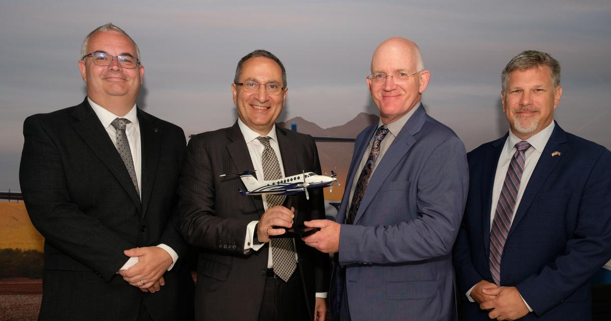 Gama Aviation group CEO Marwan Khalek (left center) and Bob Scott, Textron Aviation's special missions sales (right center)