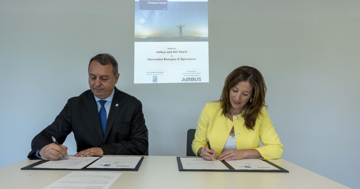 Luis Felipe de Oliveira, ACI World director general & CEO, and Airbus chief sustainability officer Julie Kitcher, sign aviation sustainability agreement