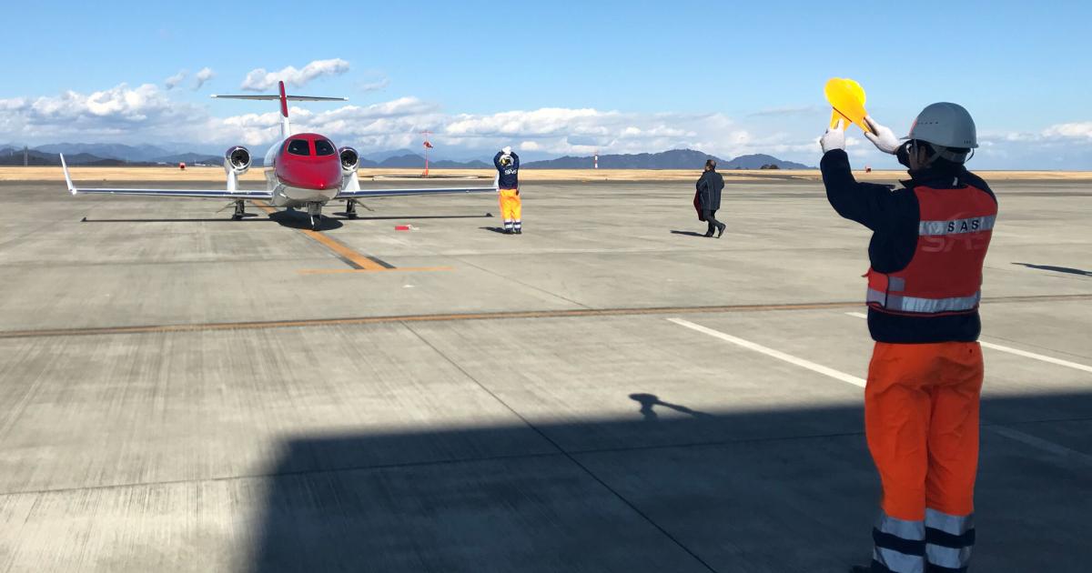 Marshaling business jet on ramp at Tokyo Haneda Airport