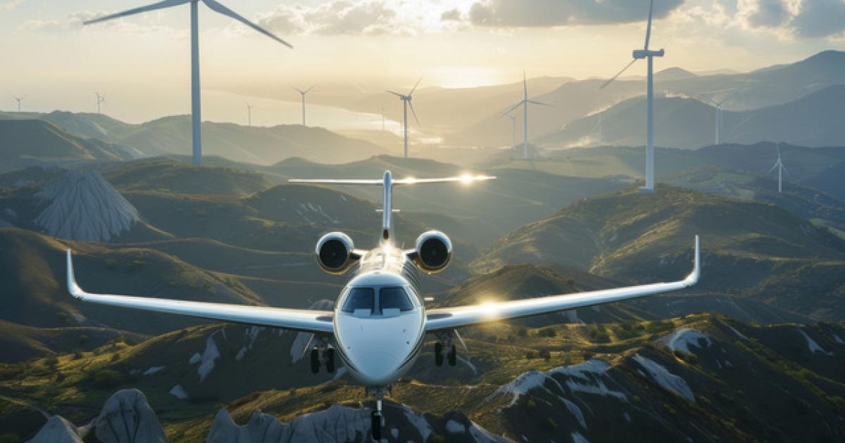 business jet in flight over wind turbines