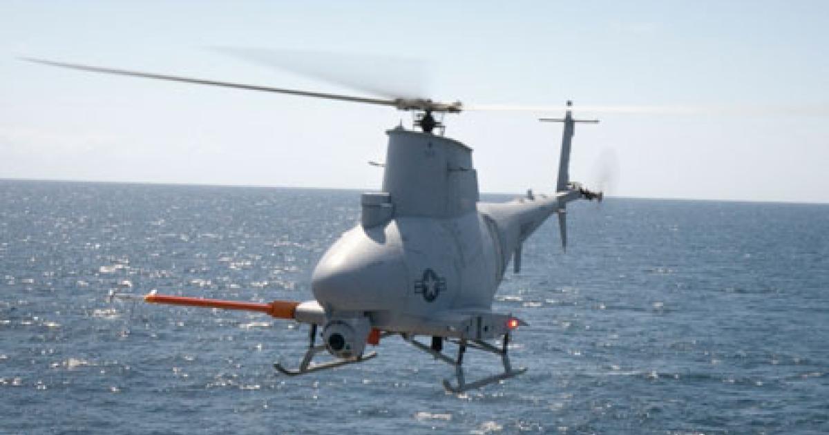 An MQ-8B Fire Scout approaches the deck of a U.S. Navy frigate at sea. The full fielding of this innovative UAS has been delayed. (Photo: Northrop Grumman) 