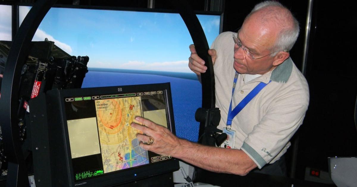 Ted Herman, Boeing Global Strike business development manager, points to a representative large area display (LAD) featured in the company’s Super Hornet Technology Demonstration Trailer. (Photo: Bill Carey)
