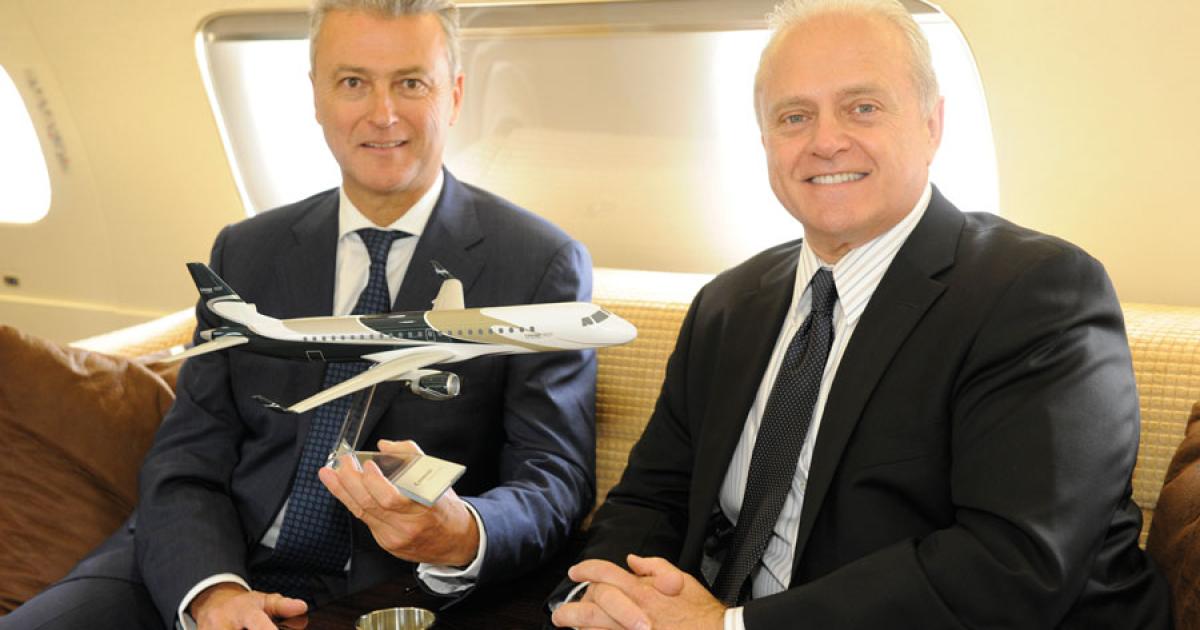 FlyingGroup CEO Bernard van Milders, left, and Embraer Executive Jets president Ernest Edwards onboard the Lineage 1000 at EBACE 2013. Milders signed for the first Lineage 1000 delivered in Belgium. The aircraft will be operated by FlyingGroup for an undisclosed European customer. (Photo: Mark Wagner)