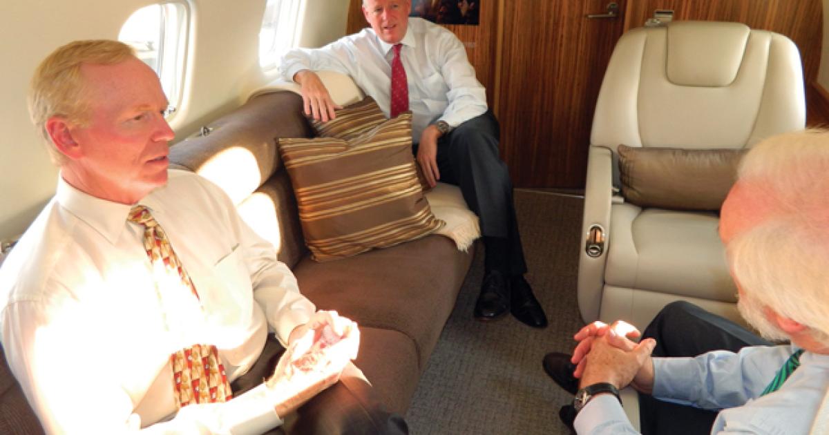 L-r: Embraer’s Robert Knebel and Christian Kennedy chat with this magazine’s editor aboard the Legacy 650 last month. (Photo: R. Randall Padfield)