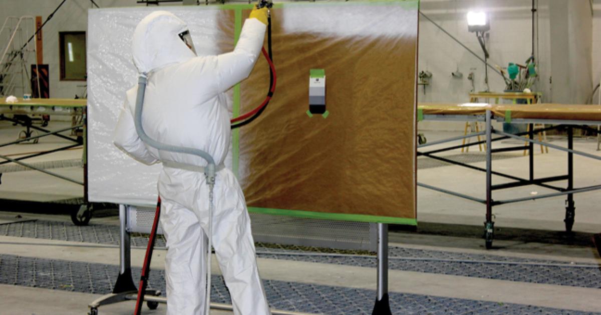 SSPC proctor observing, a StandardAero painter demonstrates proper paint application technique.