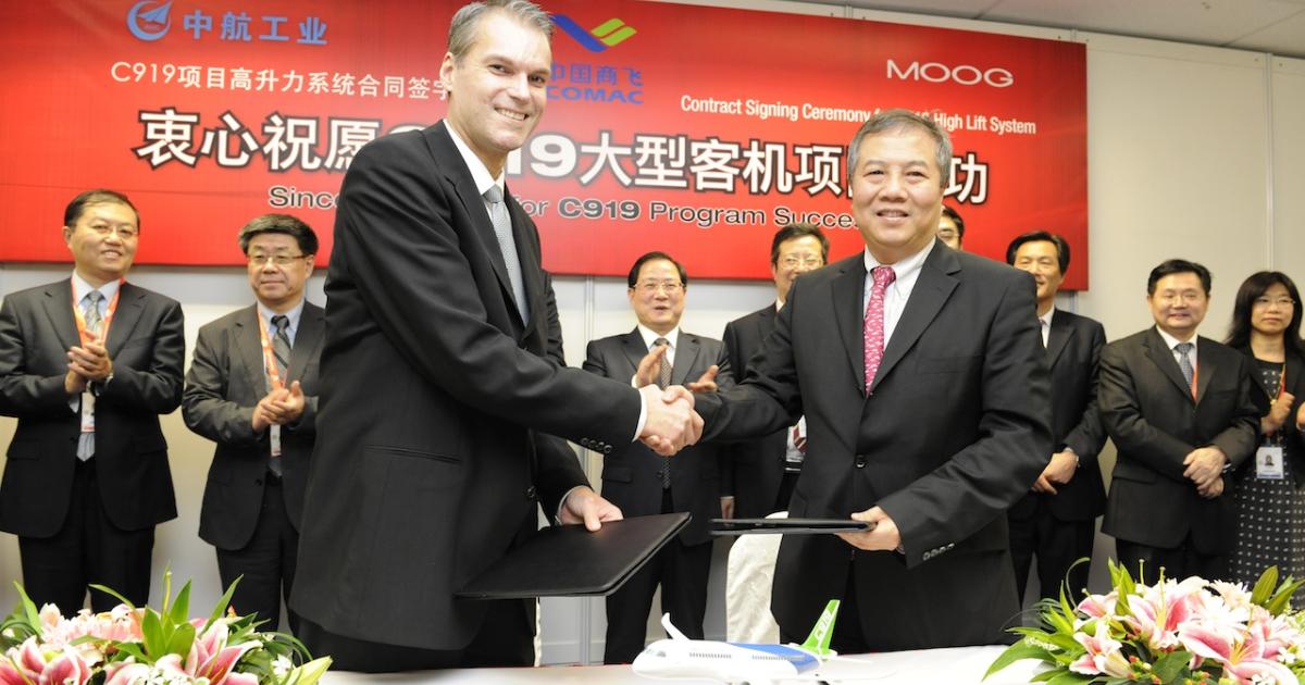 Moog general manager Paul Otto (left) sealed a letter of intent, signed in 2010, to supply components for the Comac C919, with Ding Kai, president Avic Qingan. Photo by Mark Wagner.