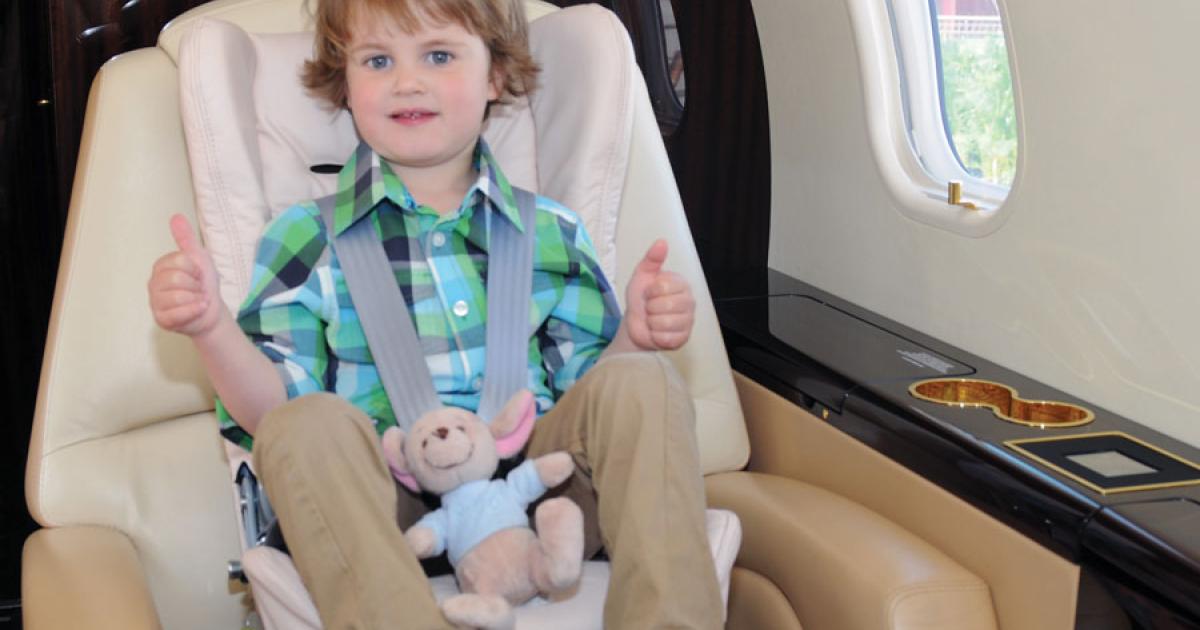 A young passenger offers his assessment of the new child seat from Gama Engineering.