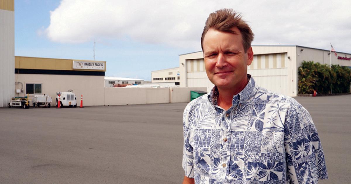 Bradley Pacific executive vice president and general manager Shaen Tarter stands on the ramp at the FBO chain's Honolulu facility. Though the stiff trade winds wreak havoc with his hair, they keep the Hawaiian Islands a constant 75 to 85 degrees F year-round. Because it is so temperate, transient aircraft are parked on the ramp at its six Hawaiian FBOs, and only Bradley's Honolulu facility even has a hangar.