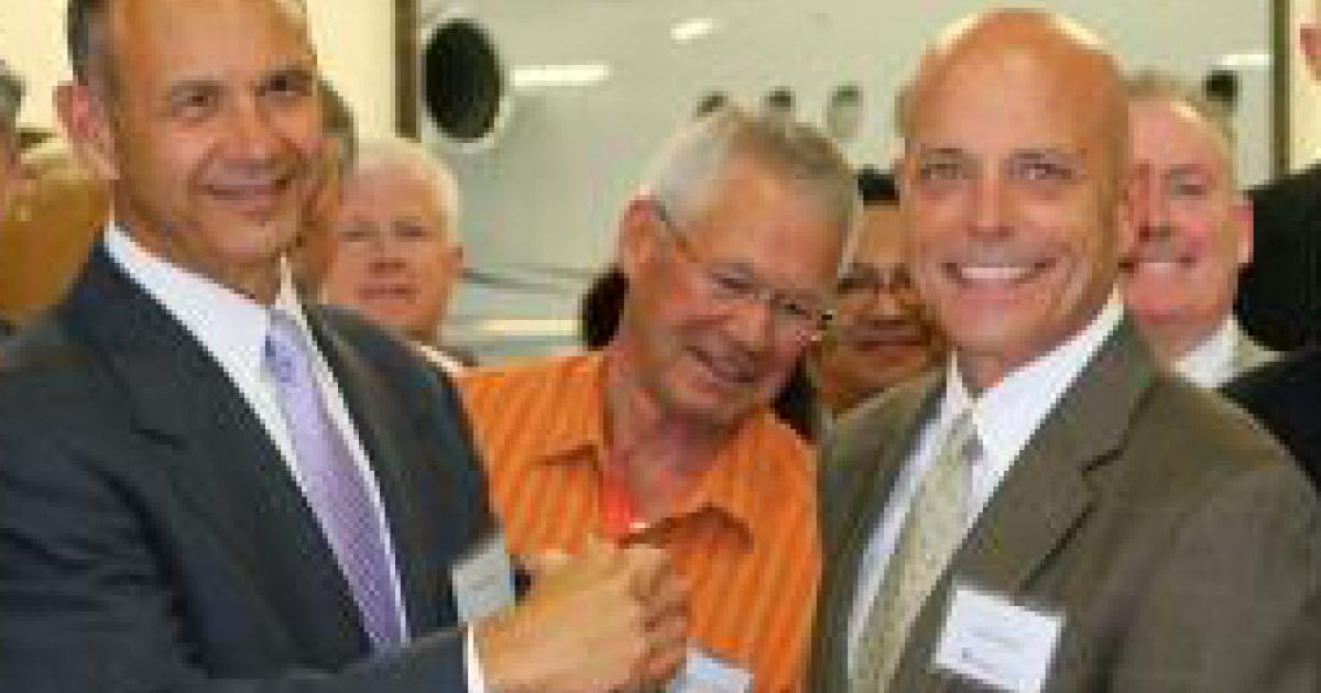 Jeff Mihalic, president of Western Aircraft, and Jim Ziegler, president and CEO of Greenwich AeroGroup celebrate Western’s expansion at a ribbon-cutting ceremony. 