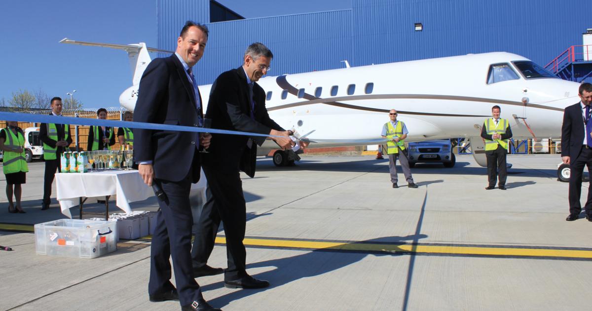 Mark Johnstone (left), Signature Flight Support EMEA managing director, and London Luton Airport CFO Elliot Renton open the new parking stand at the FBO. 

