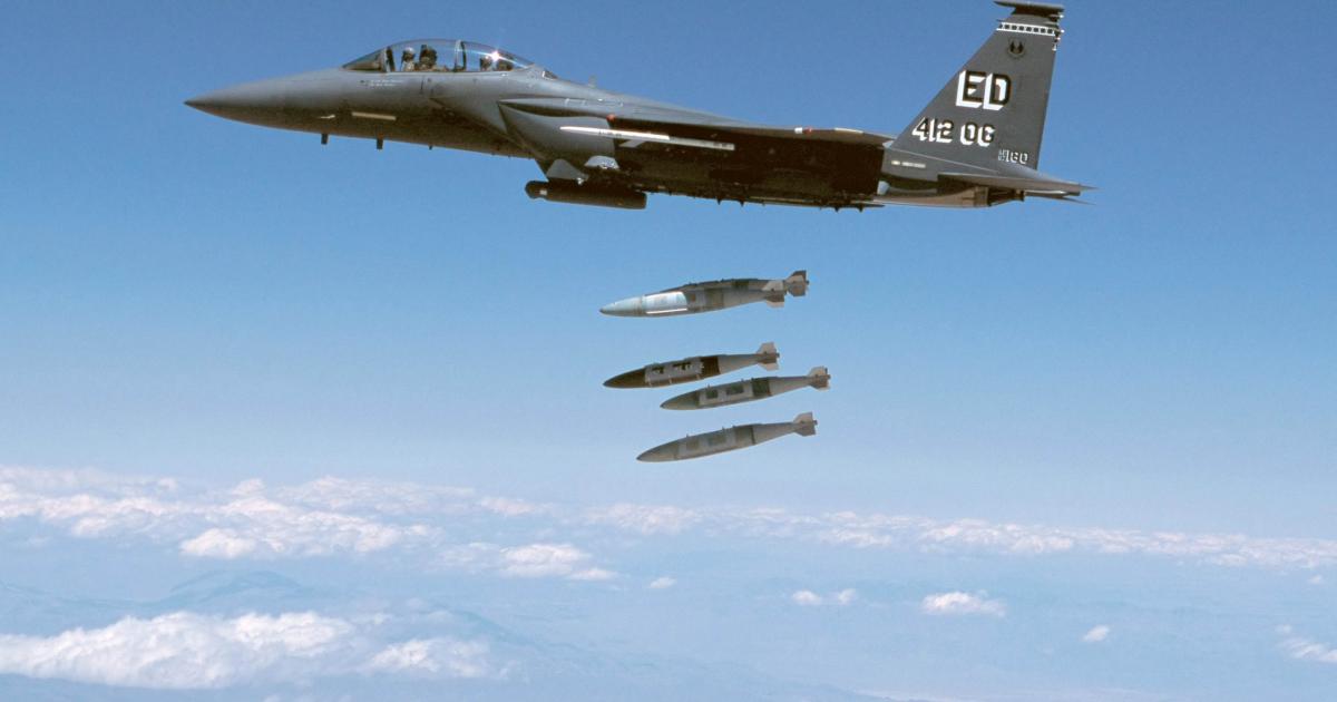 An F-15 releases multiple 500-pound bombs equipped with JDAM guidance kits during testing. (Photo: Boeing)