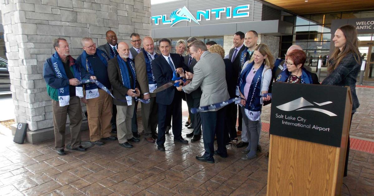 Atlantic Aviation CEO Lou Pepper (center) and vice president for midwest operations Jay Hamby (right, with back to camera)) are joined by  a group of local officials, as they cut the ribbon signaling the official opening of the service provider's new FBO at Salt Lake CIty International Airport. (Photo: Curt Epstein)