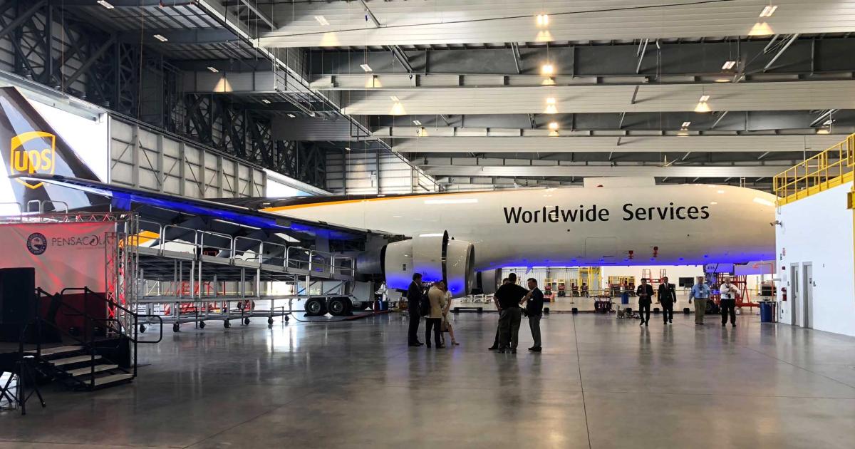 A UPS Boeing 757 freighter stood on display with many of its wing access panels removed for a C-check during the grand opening of ST Engineering Aerospace’s new 173,500-sq-ft MRO facility in Pensacola, Florida. UPS’s fleet of seventy-five 757 freighters will be cycled through the facility for these inspections, with 21 to be performed there this year and 40 per year thereafter.