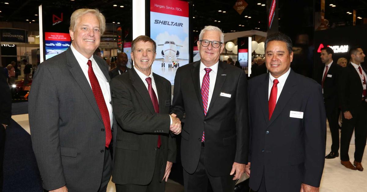 (l-r) Sheltair COO Warren Kroppel and senior vice president Frank Seymour note the closing of the deal with Argus International president and CEO Joseph Moeggenberg, and Sheltair senior vice president of FBO operations Tom Craft. Announced at NBAA's annual convention in Orlando, it will see all of the FBO chain's locations equipped with the TraqPak FBO flight tracking and historical aircraft data program.