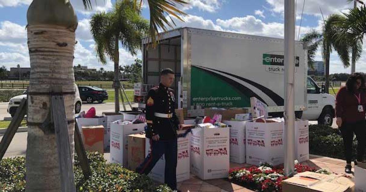 A U.S. Marine prepares to load the toys collected in a holiday drive at Florida's dedicated business aviation Boca Raton Airport. The airport authority recruited its tenants to help with the effort, that tallied more than 1,500 toys and bicycles.