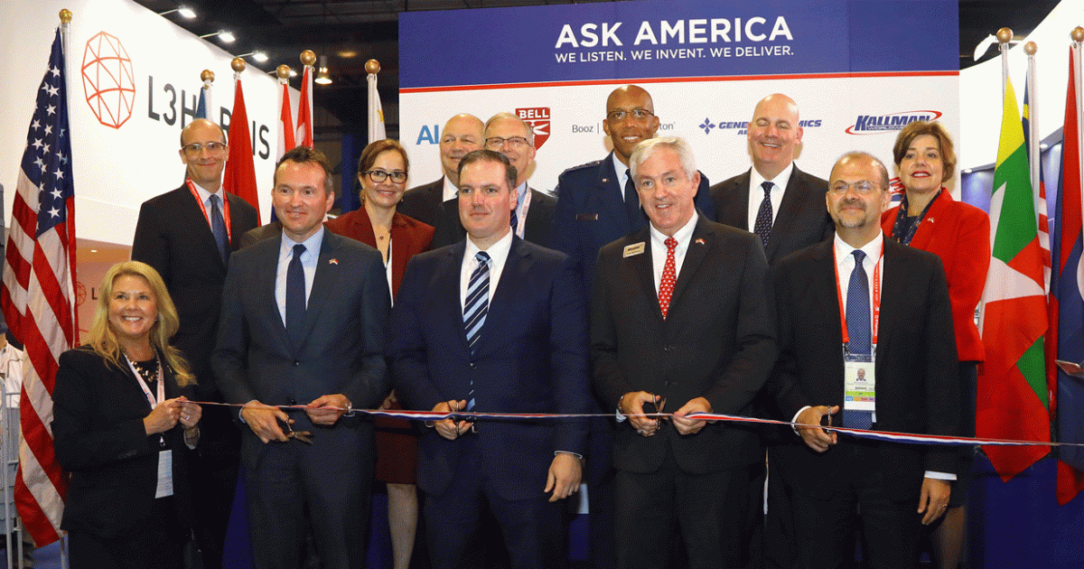 Tom Kallman (center right), president and CEO of Kallman Worldwide, welcomed Singapore Airshow visitors to the opening of the USA Partnership Pavilion. 