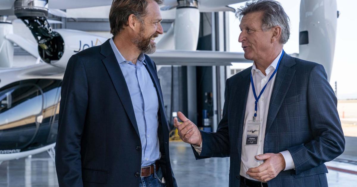 JoeBen Bevirt (left), founder and CEO of Joby, and Marc Parent, CEO and president of CAE, discuss their partnership in front of Joby's eVTOL prototype. (Image: Joby Aviation)