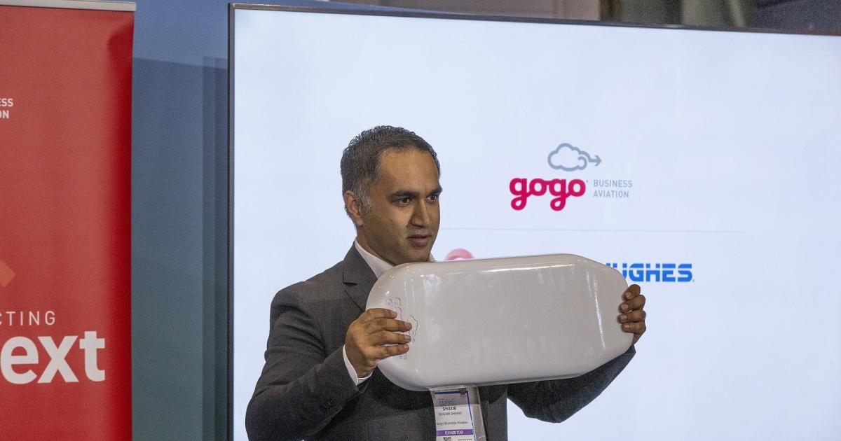 Shuaib Shahid, Gogo’s director of international sales, holds the fuselage-mounted antenna that will enable Gogo’s global broadband service.
