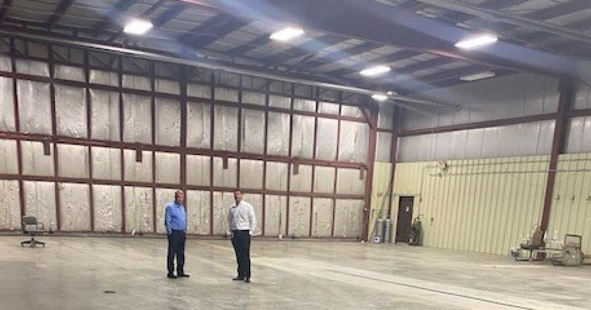 Revv Aviation CEO Guy Lieser (l.) and Quad Cities International Airport executive director Ben Leischner examine the hangar Revv will now occupy at KMLI.