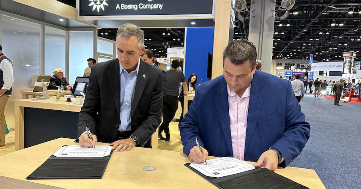 ForeFlight CEO Tim Schuetze, left, and Sun Air Jets director of operations Ed Fares sign an agreement at NBAA-BACE 2022 last week in which the Southern California-based charter operator will use ForeFlight's software suite. (Photo: Sun Air Jets)