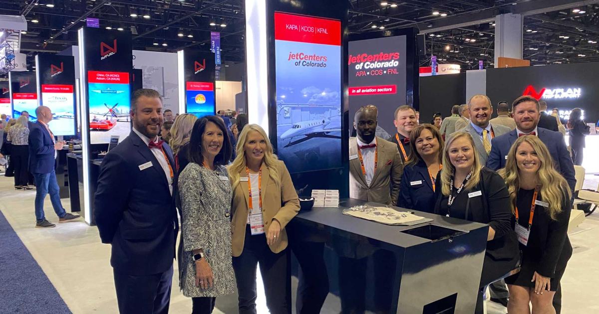 jetCenters of Colorado staffers celebrate the rebranding of their three FBO locations at NBAA-BACE in Orlando. (Photo: Curt Epstein, AIN)