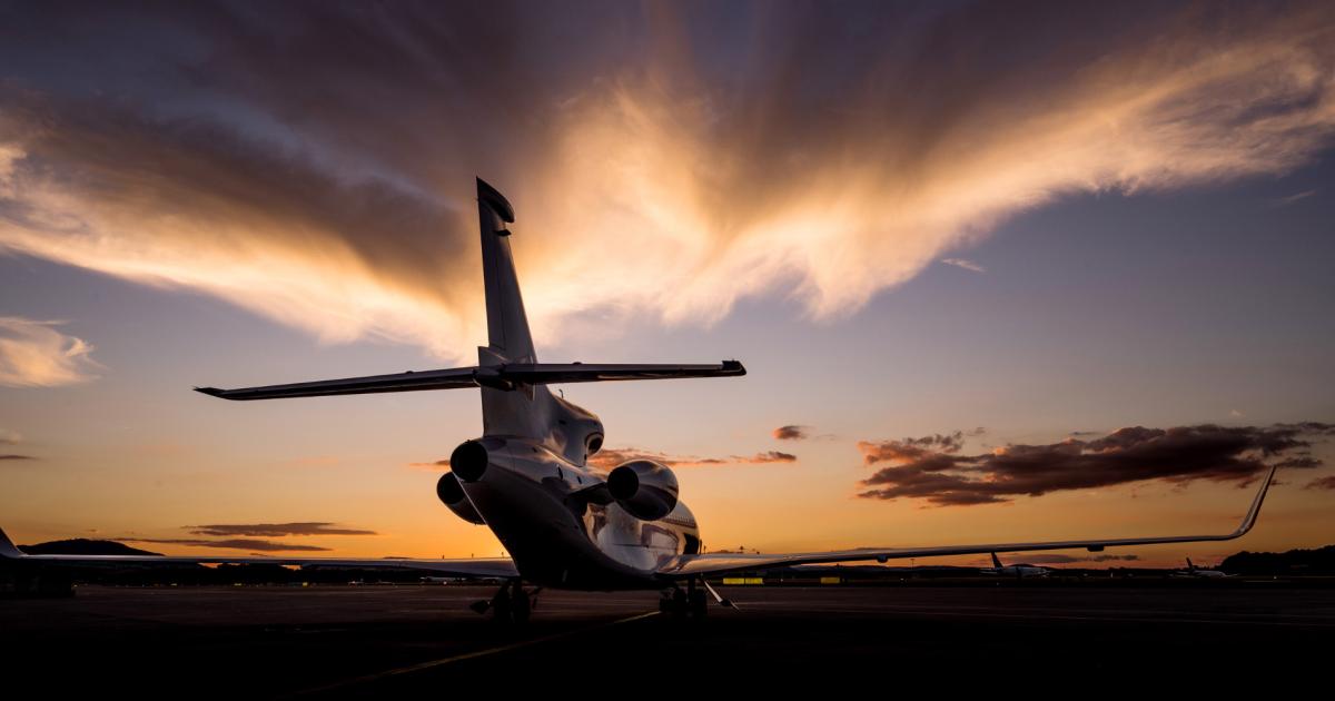 Business jet on airport ramp at sunset