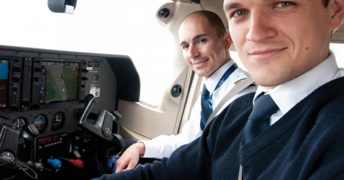 Pilots in cockpit of small aircraft
