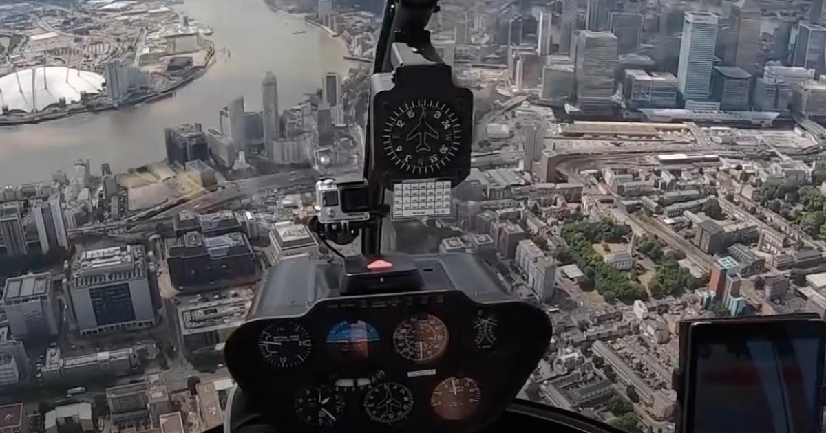 view from helicopter flight deck in flight over city