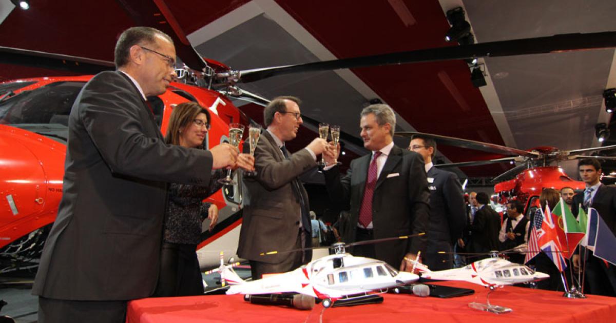 AgustaWestland and Omni Helicopters celebrate an order for nine helicopters at Heli-Expo 2014.