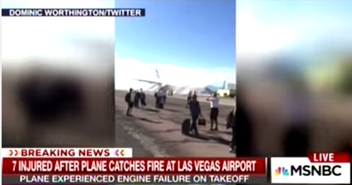 A video from Twitter shows passengers clutching their luggage after evacuation from a burning British Airways Boeing 777 at McCarran International Airport in Las Vegas. Twitter: Dominic Worthington
